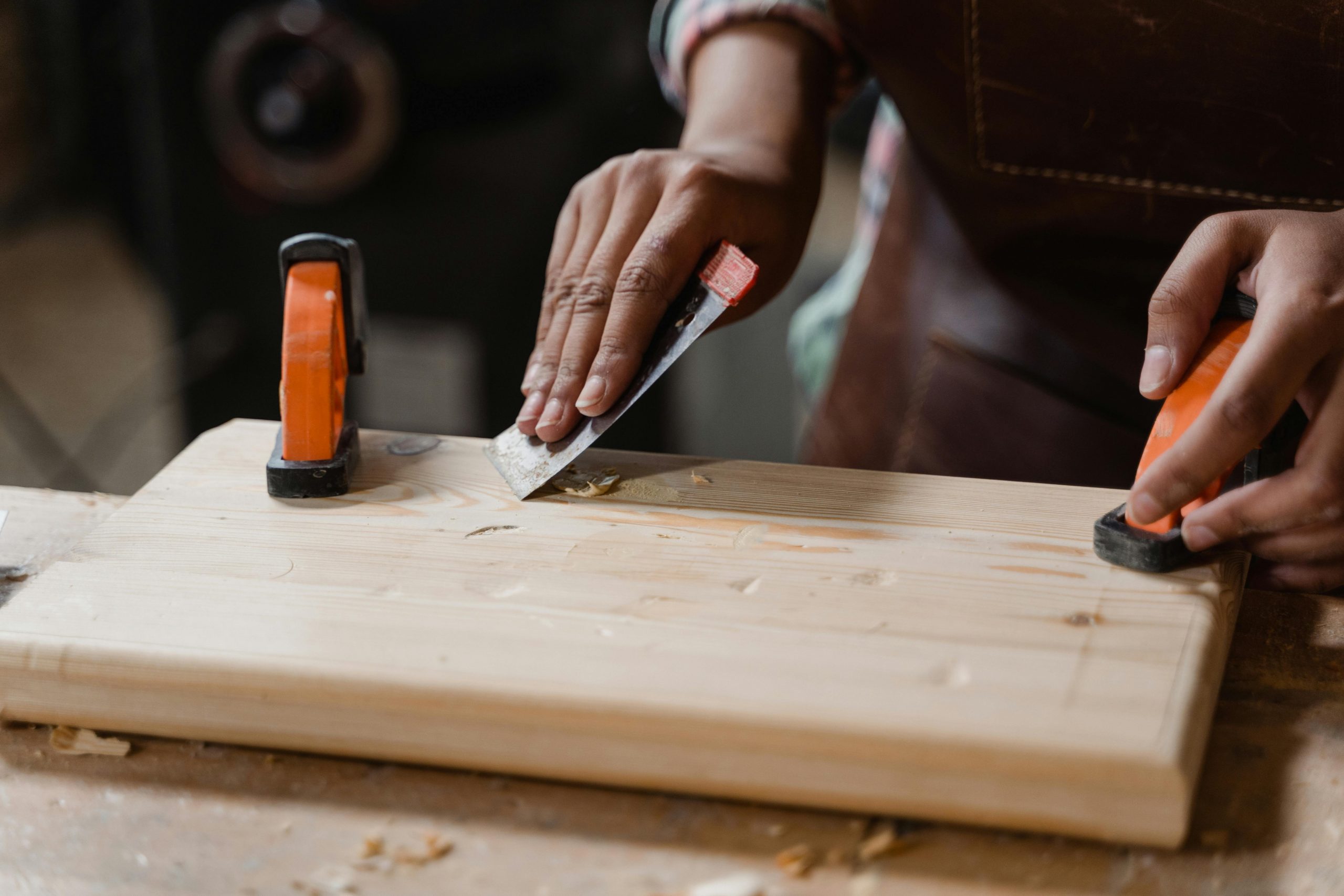 DIYer using sandpaper to smooth wood