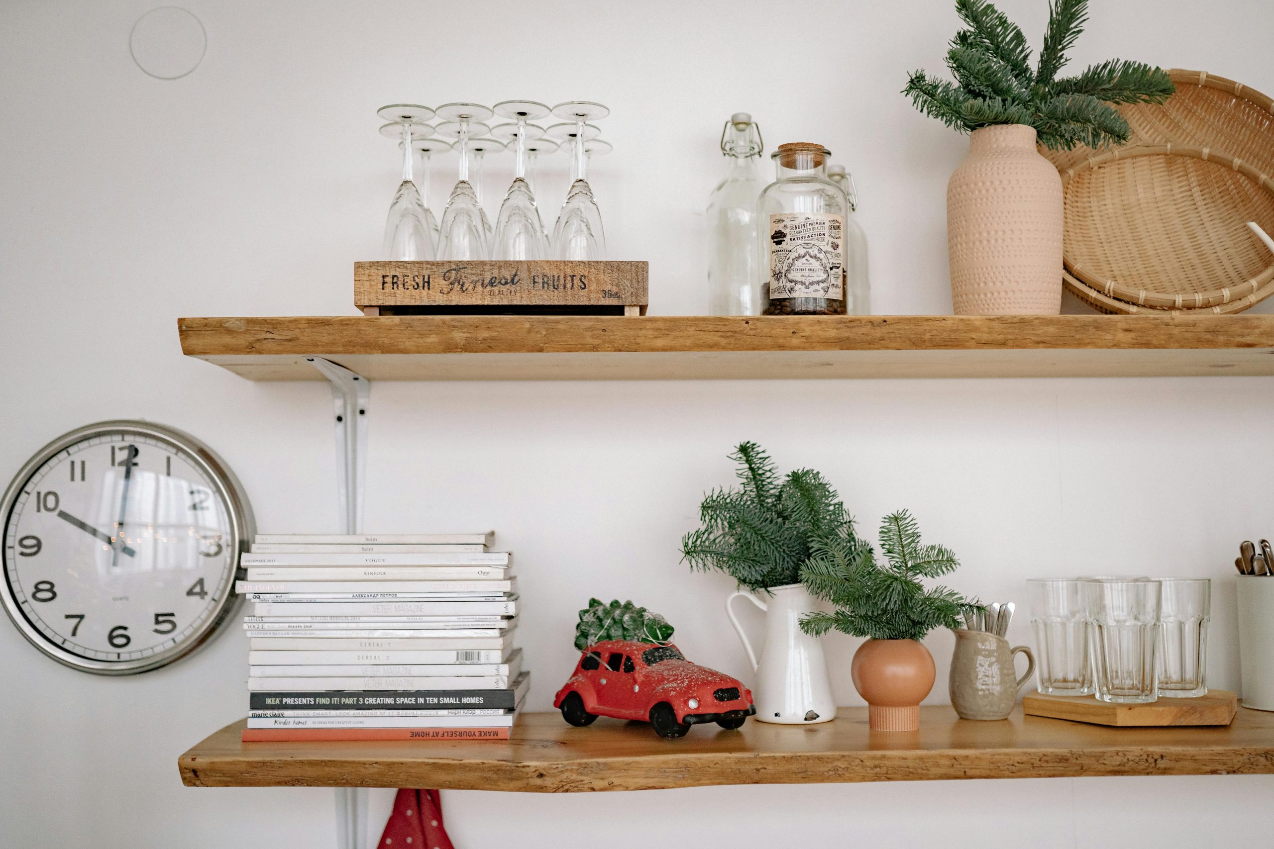 wooden floating shelves with books and assorted decor items