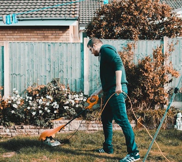 a man tending his lawn and landscaping